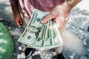 a person holding dollar bills